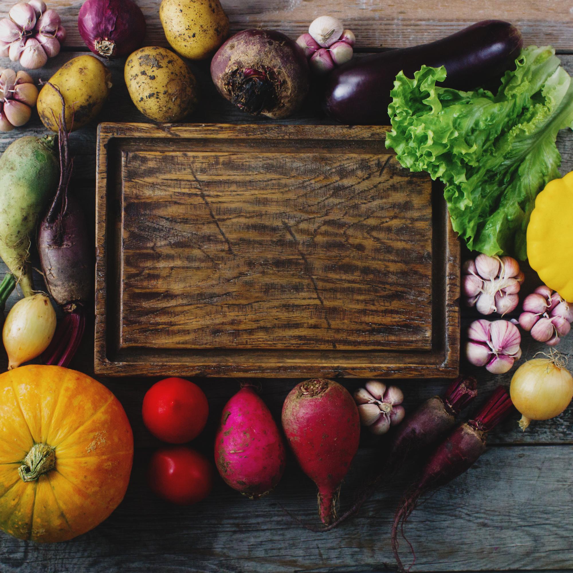Wooden board with colorful seasonal vegetables
