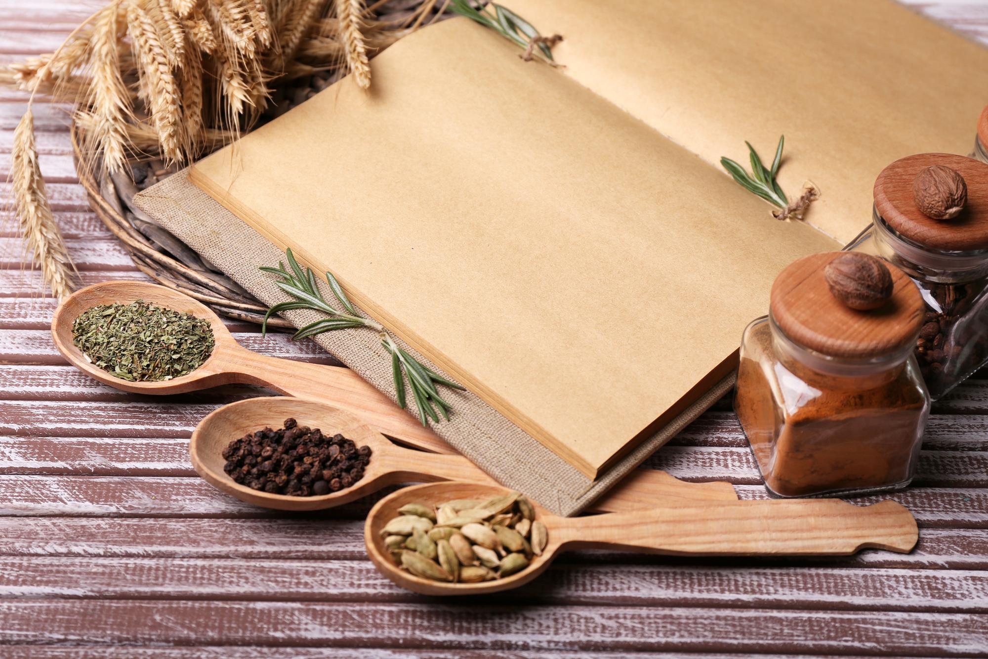 Stack of recipe booklets and herbs